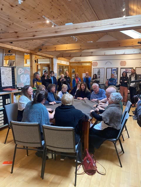 The waulking group gathered round a table at the centre