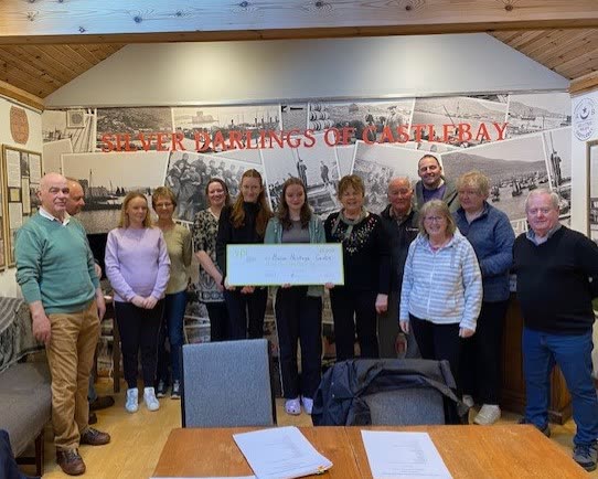 The committee receiving the YPI cheque from the pupils